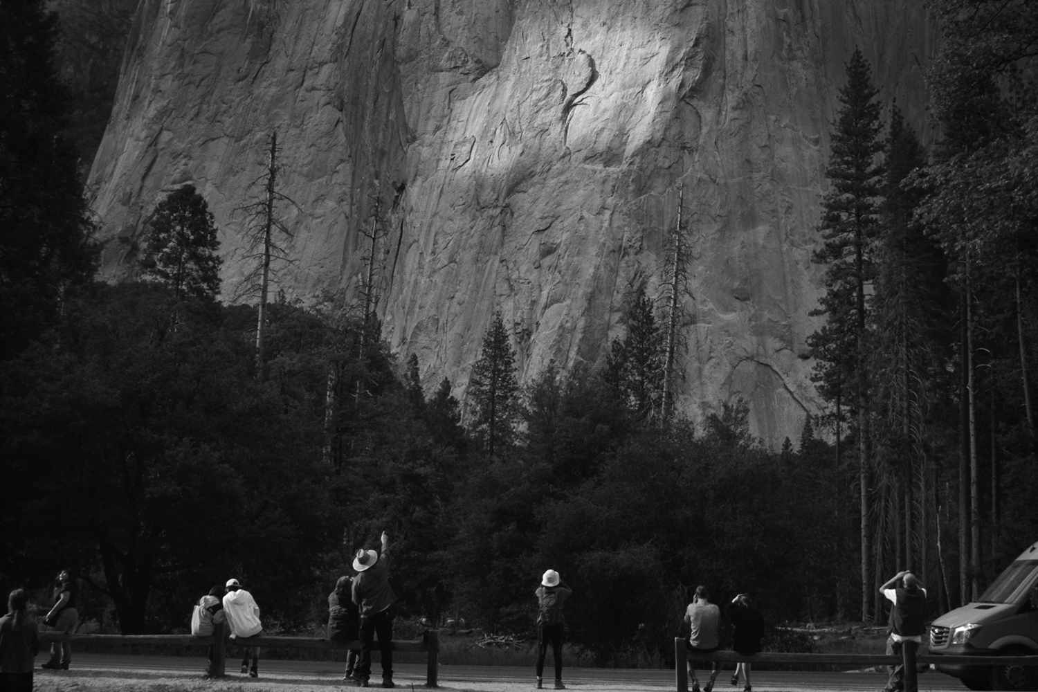 black and white photograph of tourists looking at a mountain in Yosemite